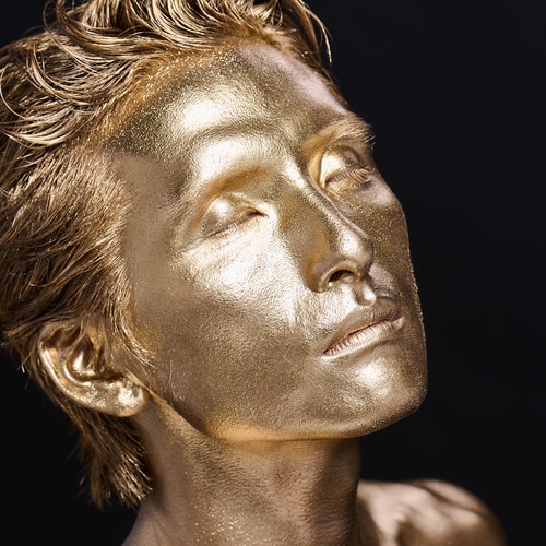 man covered with gold paint